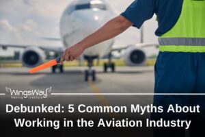 A ramp agent standing in front of an airplane on the runway with his left hand out. He is holding a glowing stick to lead the plane. aviation myths