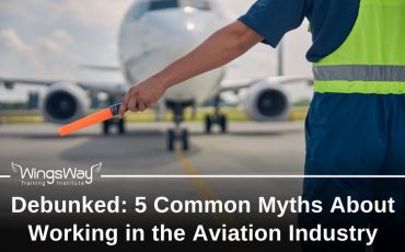 A ramp agent standing in front of an airplane on the runway with his left hand out. He is holding a glowing stick to lead the plane. aviation myths